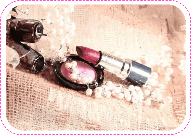A lipstick and some pearls on the ground