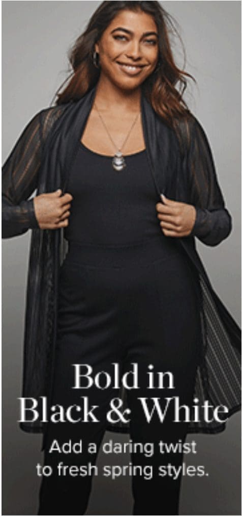 Woman in stylish black outfit smiling confidently.